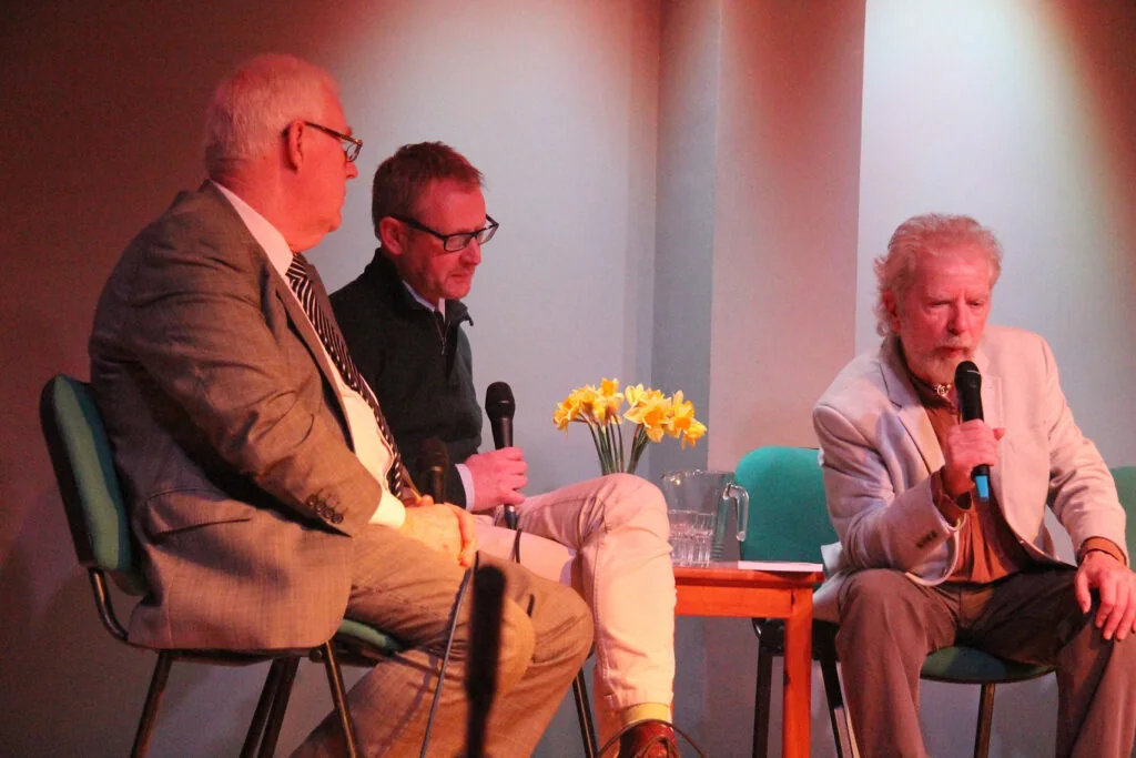 Tommy Sands in conversation with two other speakers