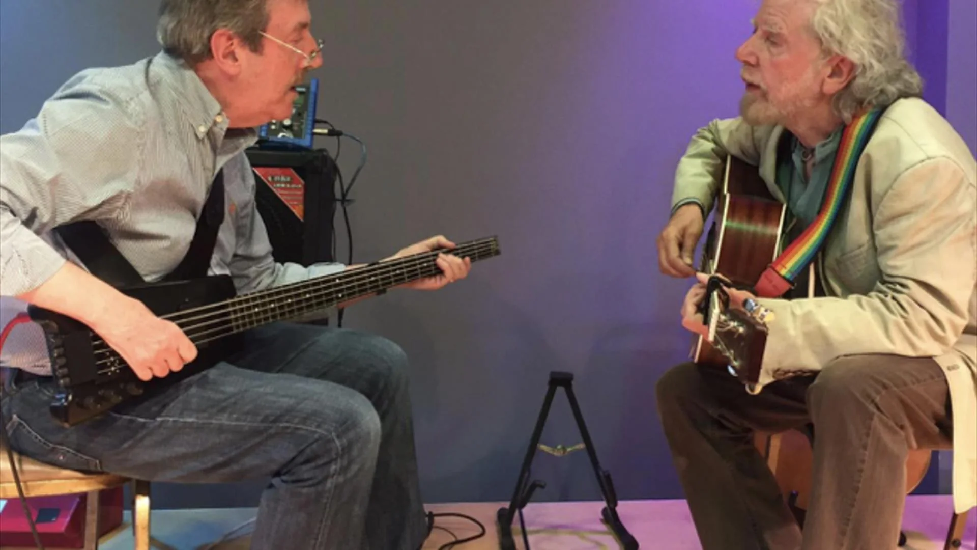 Tommy Sands playing guitar with a fellow musician at Fiddler’s Green in Rostrevor
