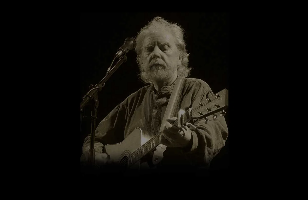 Tommy Sands singing and playing acoustic guitar