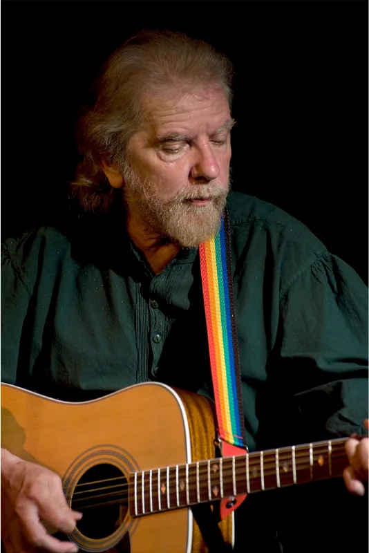 Tommy Sands playing acoustic guitar