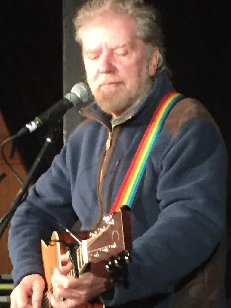 Tommy Sands singing and playing guitar on stage